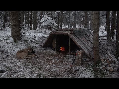 Survival earth lodge cabin, sudden snow storm, fire oven inside made a chimney out of clay and stone