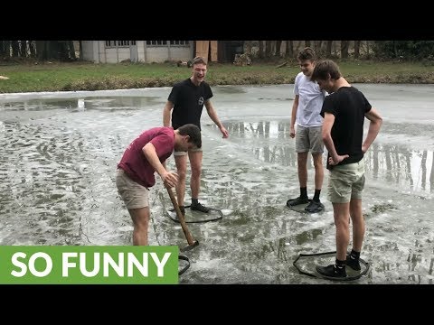 Kids on frozen lake play a game trying to break ice with a razor sharp axe on a slippery surface